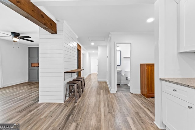 interior space featuring recessed lighting, a ceiling fan, ornamental molding, light wood-type flooring, and baseboards