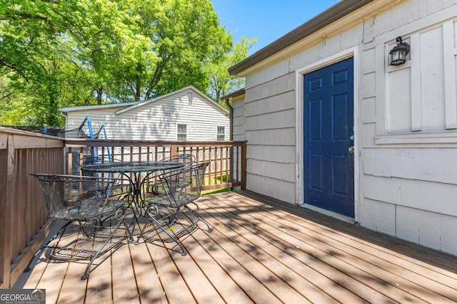 wooden terrace with outdoor dining area