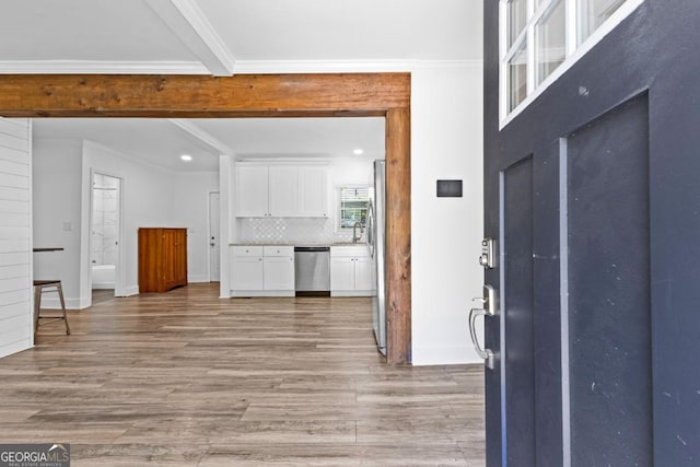 foyer entrance with recessed lighting, light wood finished floors, beamed ceiling, crown molding, and baseboards
