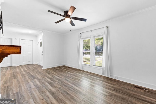 unfurnished living room featuring ornamental molding, a ceiling fan, wood finished floors, and visible vents