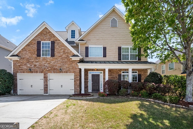 1502 Silver Mist Cir, Powder Springs, GA 30127 - view of front facade with driveway, a front yard, a standing seam roof, and a garage