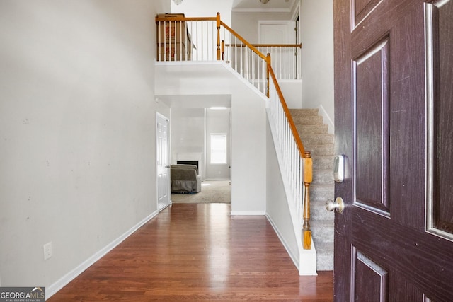 1502 Silver Mist Cir, Powder Springs, GA 30127 - entryway featuring a towering ceiling, baseboards, dark wood-style floors, and stairway