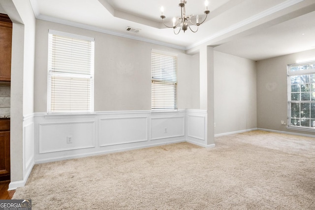 1502 Silver Mist Cir, Powder Springs, GA 30127 - empty room with a wainscoted wall, visible vents, light carpet, crown molding, and a notable chandelier