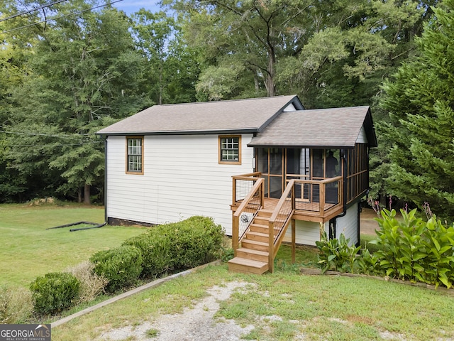 1271 Hayes St, Madison, GA 30650 - view of front of home featuring a sunroom, a front lawn, stairway, and roof with shingles