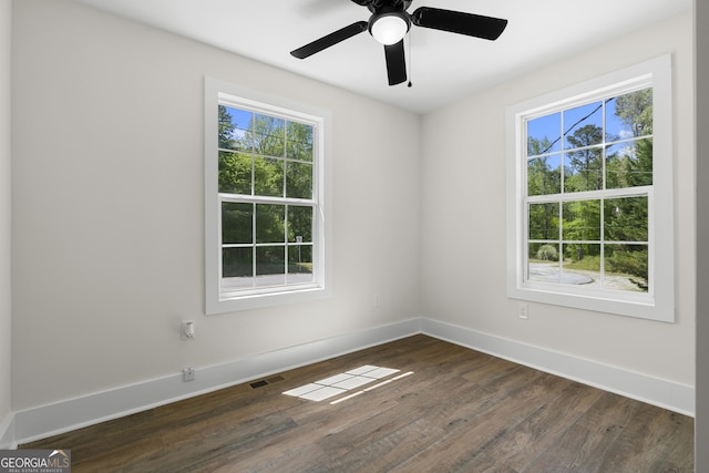 1271 Hayes St, Madison, GA 30650 - unfurnished room featuring baseboards, visible vents, a ceiling fan, and dark wood-style floors