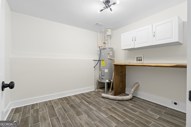 1271 Hayes St, Madison, GA 30650 - laundry area featuring water heater, cabinet space, hookup for a washing machine, and baseboards