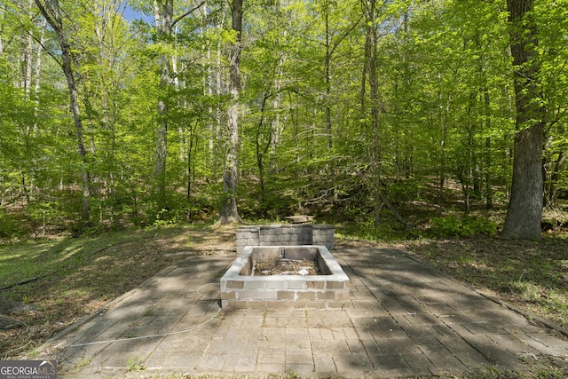 1271 Hayes St, Madison, GA 30650 - view of patio / terrace featuring a forest view and an outdoor fire pit