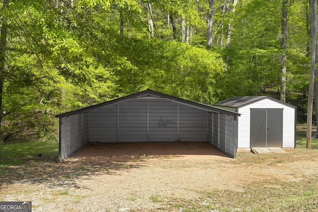 1271 Hayes St, Madison, GA 30650 - garage featuring a shed and a detached carport