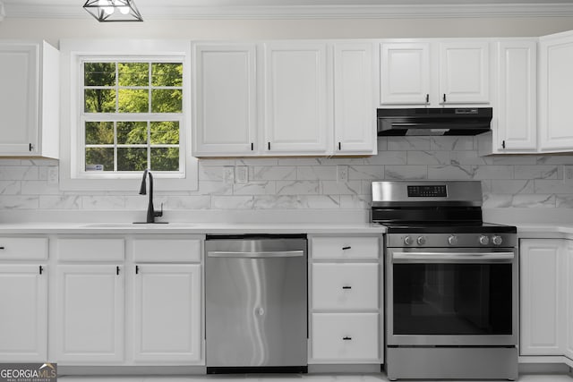 1271 Hayes St, Madison, GA 30650 - kitchen featuring under cabinet range hood, light countertops, a sink, crown molding, and appliances with stainless steel finishes