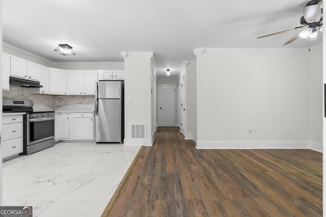 1271 Hayes St, Madison, GA 30650 - kitchen with a ceiling fan, under cabinet range hood, stainless steel appliances, baseboards, and ornamental molding