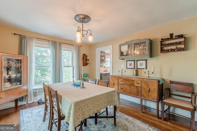 dining area with dark wood-style flooring