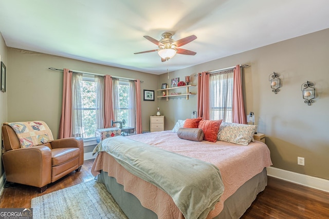 bedroom with baseboards, wood finished floors, and ceiling fan