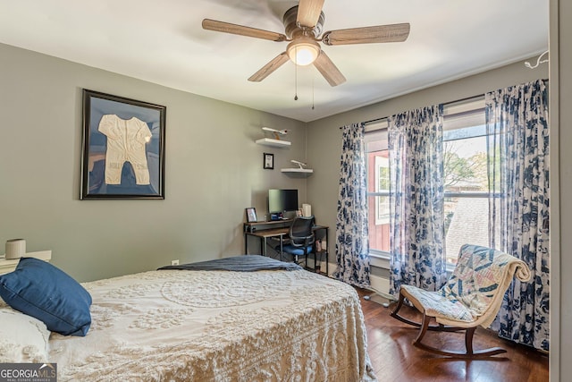 bedroom with a ceiling fan and dark wood finished floors