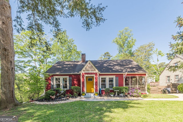 view of front facade featuring a chimney and a front yard
