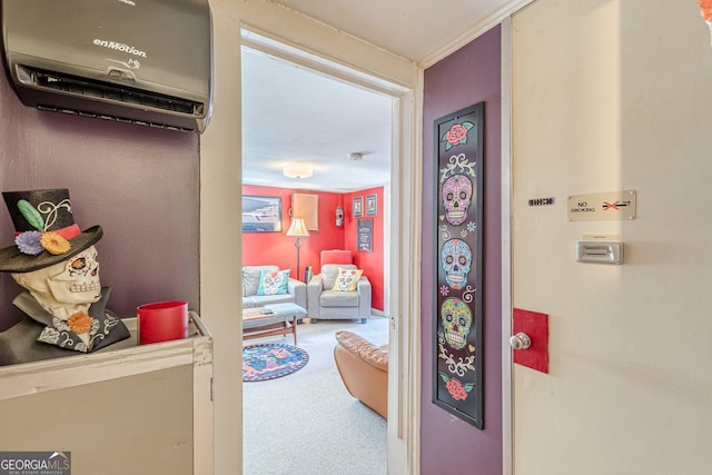 interior space with a wall unit AC and carpet