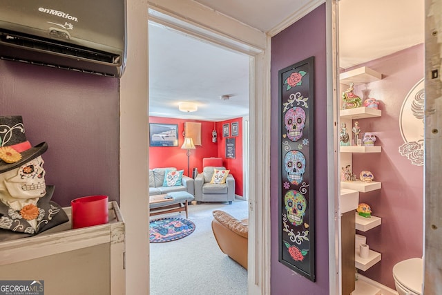 hall with a wall mounted AC and carpet