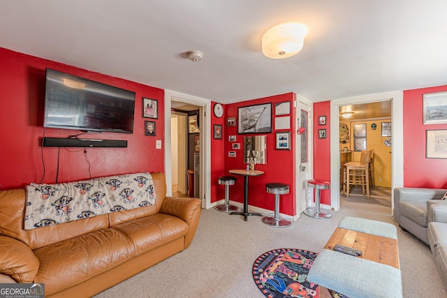 carpeted living room featuring baseboards