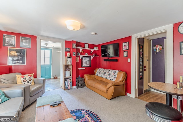 living room with baseboards and carpet