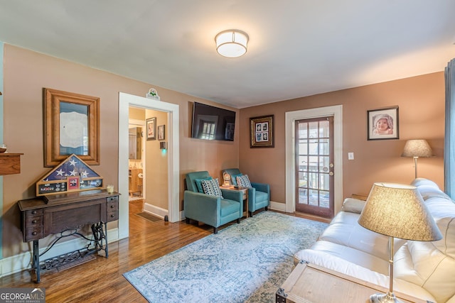 living area with wood finished floors and baseboards