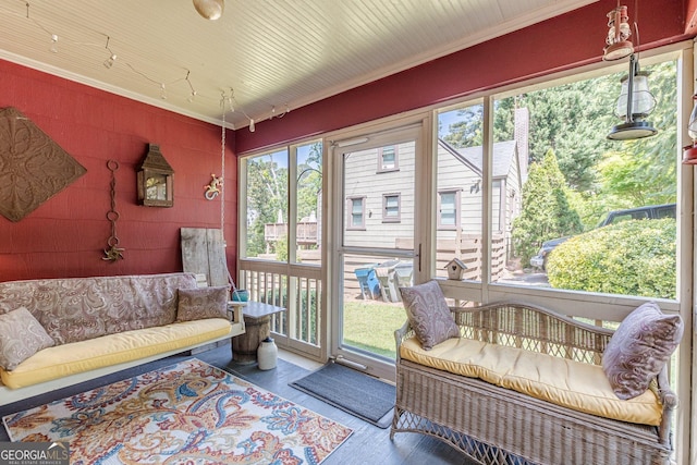 sunroom featuring outdoor lounge area and a wealth of natural light