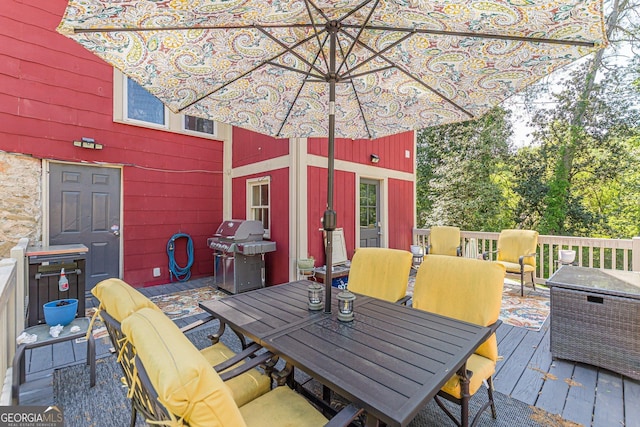 deck featuring grilling area and outdoor dining space