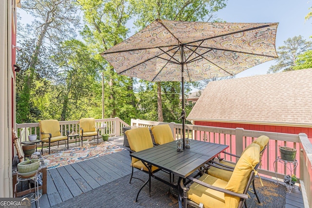 deck featuring outdoor dining area