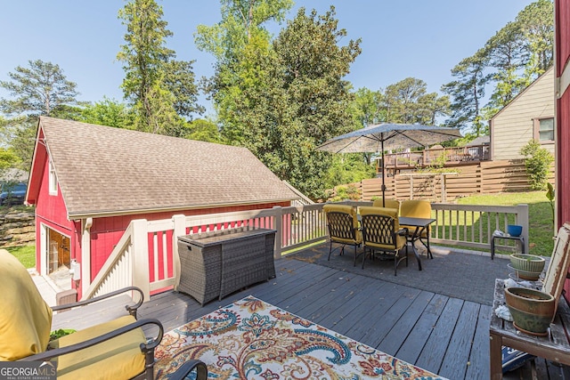 wooden terrace featuring outdoor dining area