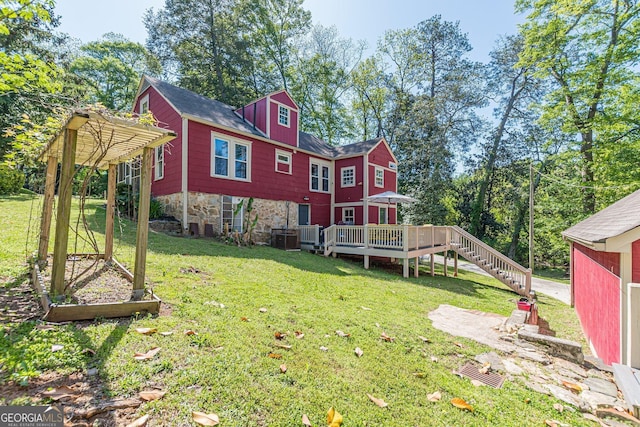 exterior space with a lawn, a wooden deck, and stairway