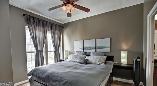 195 14th St Unit 1403, Atlanta, GA 30309 - bedroom featuring light wood-type flooring, a textured ceiling, and a ceiling fan