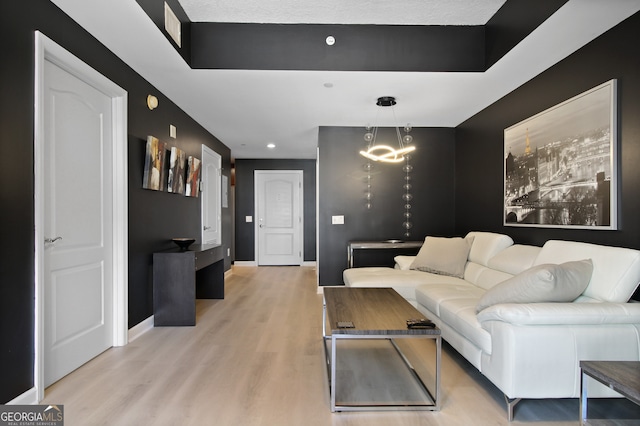 195 14th St Unit 1403, Atlanta, GA 30309 - living room with light wood finished floors, a chandelier, and recessed lighting