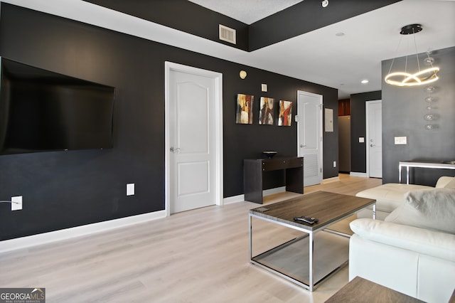 195 14th St Unit 1403, Atlanta, GA 30309 - living area with light wood-type flooring, a chandelier, and recessed lighting