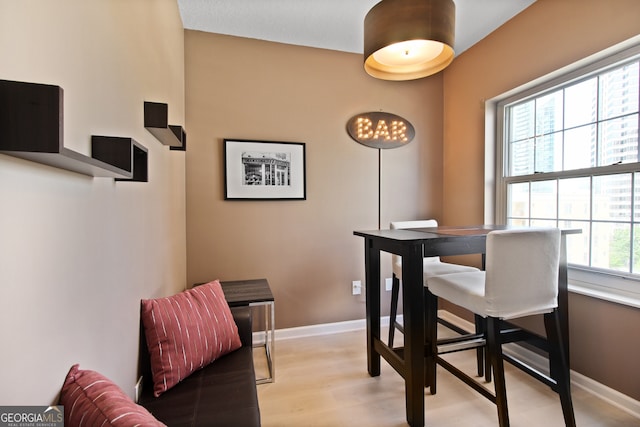 195 14th St Unit 1403, Atlanta, GA 30309 - dining space with light wood-type flooring and a chandelier