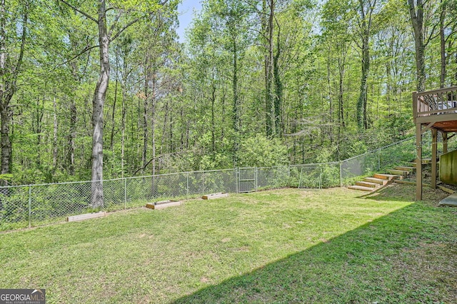 view of yard with a fenced backyard, stairway, and a deck