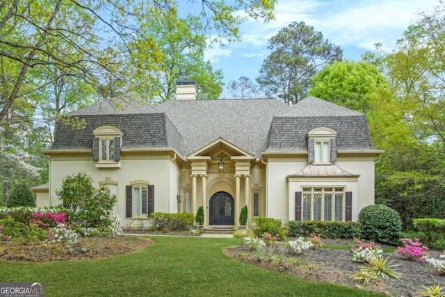 315 Mossy Pointe, Duluth, GA 30097 - view of front of house with roof with shingles, a chimney, a front lawn, and stucco siding