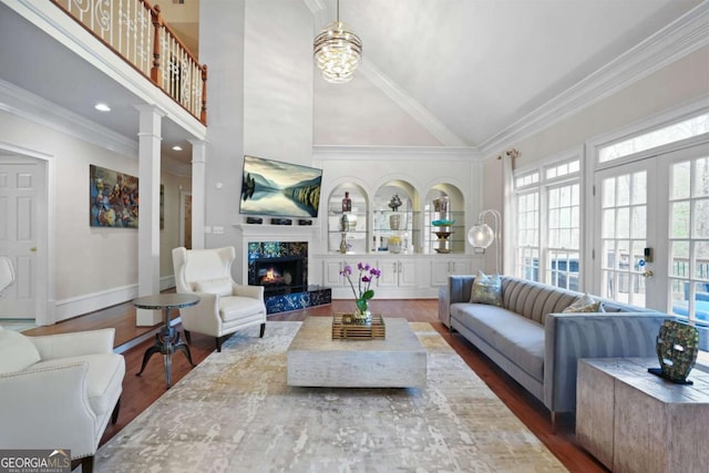 315 Mossy Pointe, Duluth, GA 30097 - living area with high vaulted ceiling, dark wood-style flooring, crown molding, and a fireplace