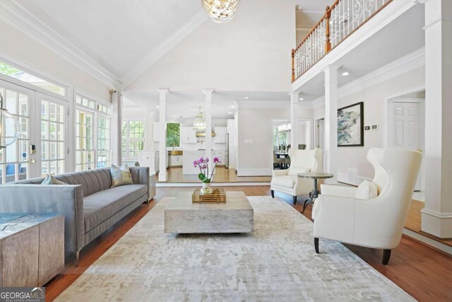 315 Mossy Pointe, Duluth, GA 30097 - living area featuring ornamental molding, wood finished floors, and ornate columns