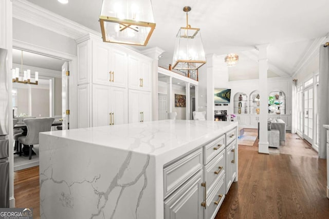 315 Mossy Pointe, Duluth, GA 30097 - kitchen featuring white cabinets, open floor plan, a chandelier, light stone countertops, and ornamental molding