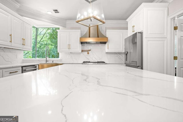 315 Mossy Pointe, Duluth, GA 30097 - kitchen featuring wall chimney exhaust hood, stainless steel appliances, white cabinets, a sink, and visible vents