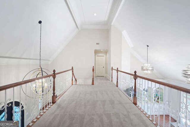 315 Mossy Pointe, Duluth, GA 30097 - hall featuring lofted ceiling, an inviting chandelier, an upstairs landing, and ornamental molding