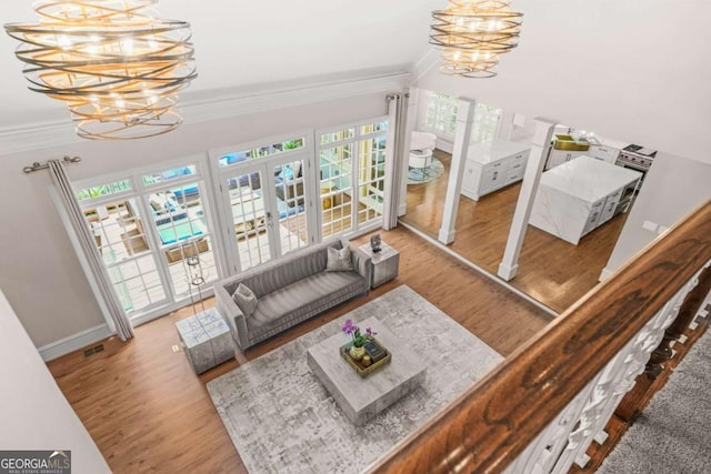 315 Mossy Pointe, Duluth, GA 30097 - living room with a chandelier, wood finished floors, baseboards, and ornamental molding