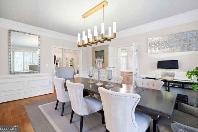 315 Mossy Pointe, Duluth, GA 30097 - dining area featuring wood finished floors, a notable chandelier, and ornamental molding