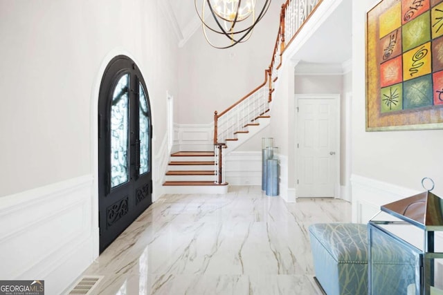 315 Mossy Pointe, Duluth, GA 30097 - foyer entrance featuring a wainscoted wall, ornamental molding, stairway, and a decorative wall