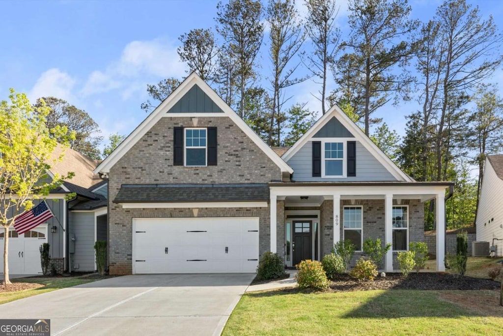 809 Kirby Dr, Woodstock, GA 30188 - craftsman inspired home with a front lawn, concrete driveway, board and batten siding, an attached garage, and a porch