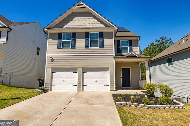 view of front of house with concrete driveway, an attached garage, roof mounted solar panels, and a front lawn