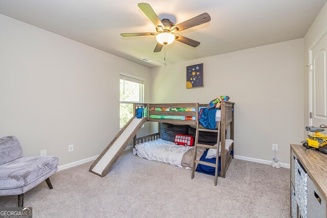 carpeted bedroom featuring visible vents, baseboards, and ceiling fan