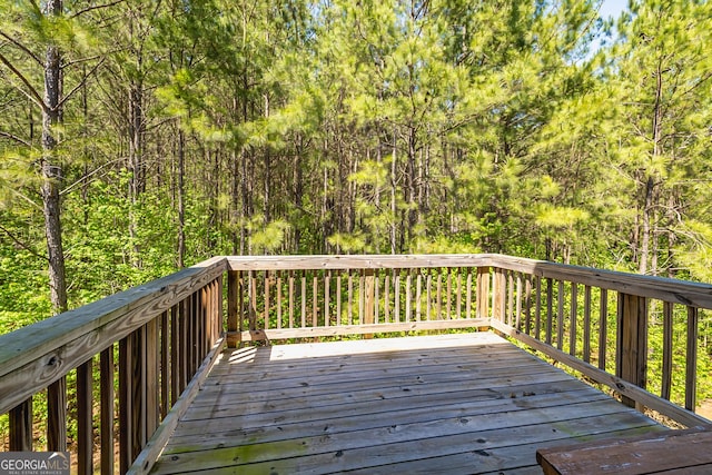 deck featuring a wooded view