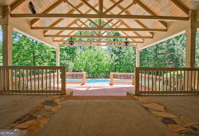 deck with ceiling fan and a swimming pool