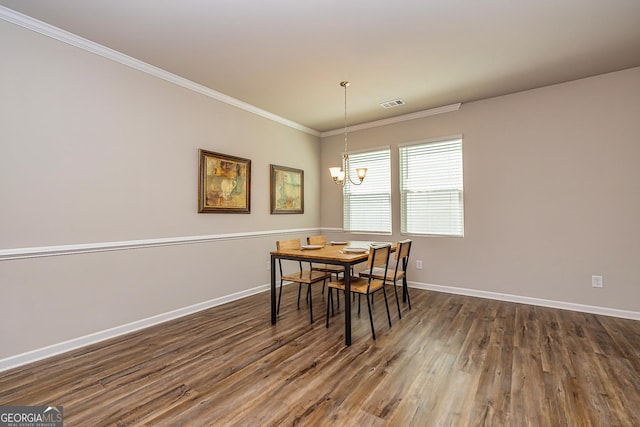 dining room with dark wood-style floors, baseboards, visible vents, a notable chandelier, and ornamental molding