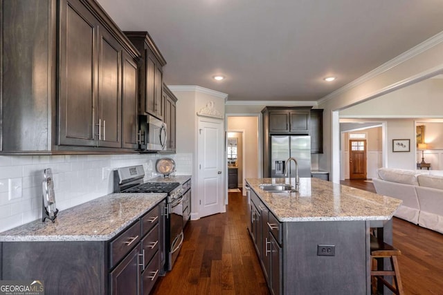 2424 Princeton Bend Way, Bogart, GA 30622 - kitchen featuring appliances with stainless steel finishes, dark brown cabinets, a kitchen bar, dark wood-style flooring, and backsplash