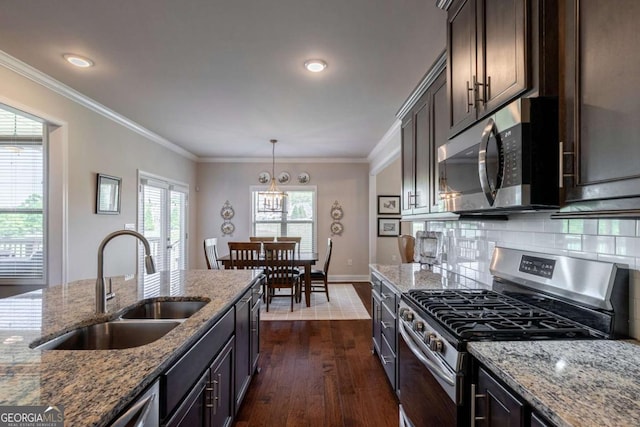 2424 Princeton Bend Way, Bogart, GA 30622 - kitchen featuring appliances with stainless steel finishes, dark wood finished floors, dark brown cabinets, light stone countertops, and crown molding